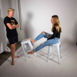 two people at a photoshoot against a white backdrop